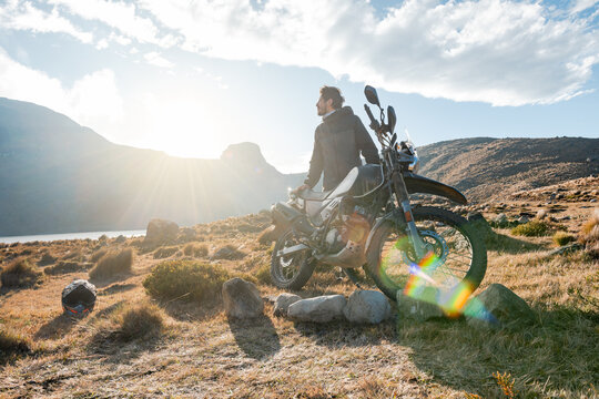 Adventure motorbike and rider on roads mountain of Peru at sunset