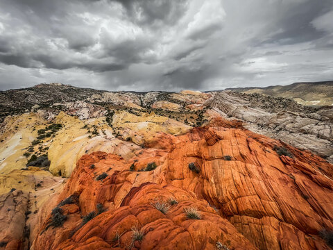 Moody clouds imply an impending storm over a colorful desert landscape