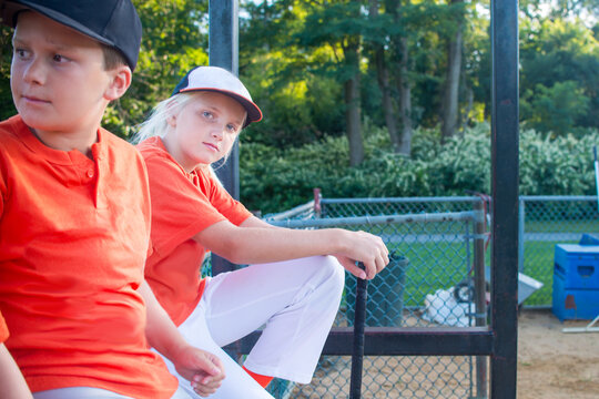 A 10 year old girl in dugout with team