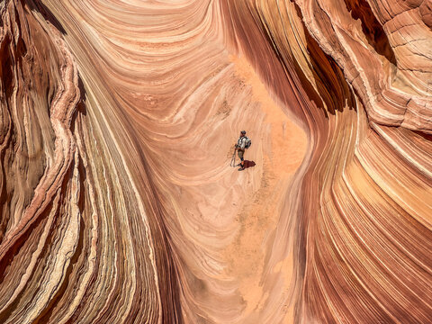 A ranger contemplates striations at the Wave