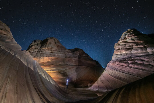 A solitary hiker at the Wave, Arizona, before dawn