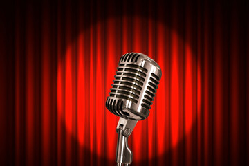 Vintage metal microphone on a red background with a spotlight, concept. Performance, stage and stand up show