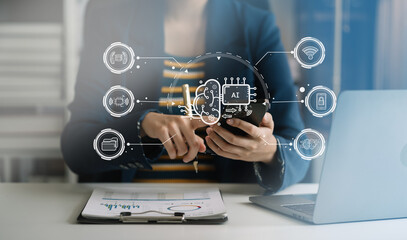 Business woman using a smartphone and laptop computer chatting with an intelligent artificial intelligence. Futuristic technology, automate Chat Bot, Smart Ai.