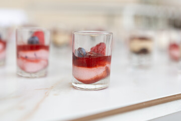 Mini dessert with cream and berries on white background