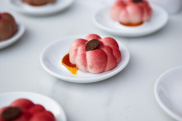 Single portion strawberry mousse on a white background