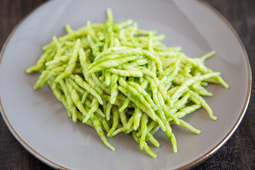 Trofie with pesto sauce, typical italian food from Liguria. Mediterranean dish suitable for those following a vegetarian diet.