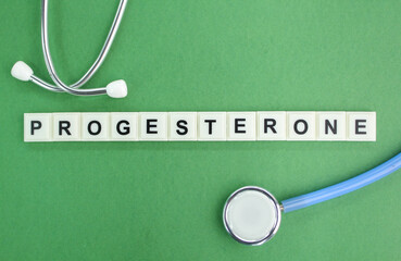 stethoscope and alphabet letters with the word PROGESTERONE. concept of medicine and disease