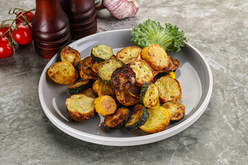 Roasted young zucchini in the plate