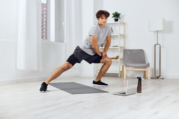 man indoor gray sportswear lifestyle dumbbells health activity home training sport