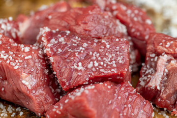 sliced piece of fresh raw beef during salting