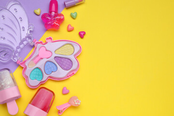 Children's kit of makeup products and accessories on color background, flat lay. Space for text