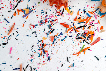 shavings and pieces of lead on paper after sharpening pencils