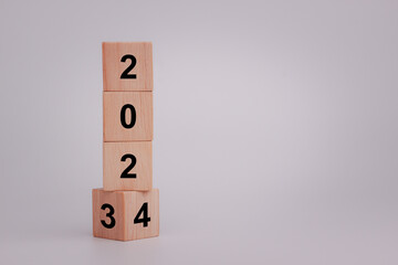 From 2023 to 2024. Flipping of 2023 to 2024 on wooden cube blocks. Beginning and start of the new year 2024. Preparation for new year, life, business, plan, goals, target and strategy concept.