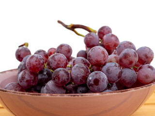 Red grapes on a white background. Ripe grapes close-up.