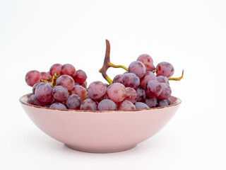 Red grapes on a white background. Ripe grapes close-up.