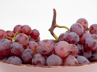 Red grapes on a white background. Ripe grapes close-up.
