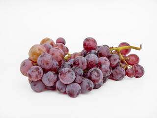 Red grapes on a white background. Ripe grapes close-up.