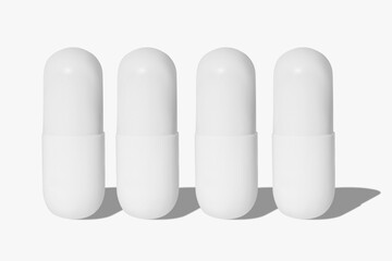 White tablets and pills. On a light background.