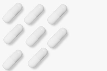 White tablets and pills. On a light background.