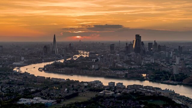 Panoramic sunset to night time lapse view of the urban skyline of London, United Kingdom, with River Thames and the City skyscrapers