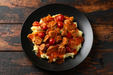 Devilled Sausages with mashed potato, spiced tomato and apple sauce.