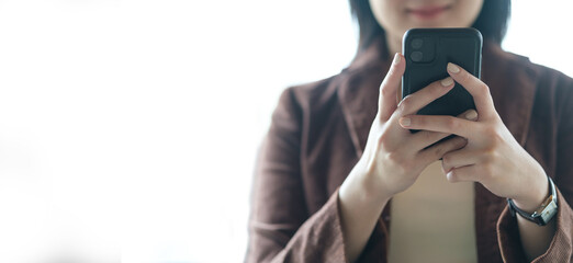 Businesswoman using mobile phone on white background. Communication, business lifestyle and technology concept