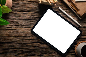 Top view modern workspace with digital tablet, stylus pen and coffee cup on wood table.