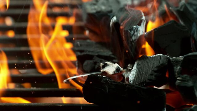 Super Slow Motion Shot of Glowing Charcoal Briquettes on Garden Grill. Filmed on High Speed Cinematic Camera at 1000 FPS.
