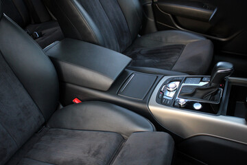 Modern car armrest. Car inside, cup holders door and armrest, black leather seats.