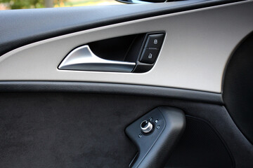 Obraz na płótnie Canvas Door handle with power window control. Car interior details. Modern car interior.