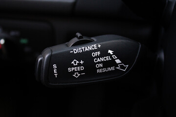 Closeup of adaptive cruise control leaver. Cruise control switch, Car parts.