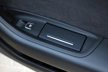 Car window control button. Box in the car door. Ashtray in passenger door.