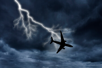 silhouette of an airplane hit by a lighting and falling 