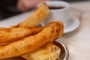 Churros on a cafe table in Seville, with a shallow depth of field