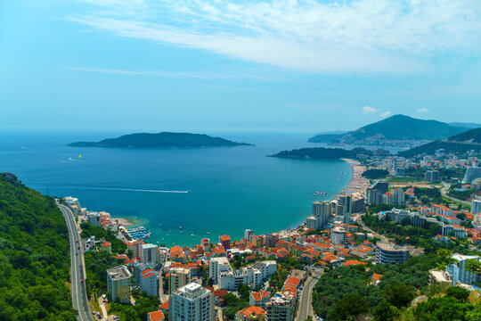 aerial view of the city on the seashore and mountains, panorama of the resorts of Becici and Budva in Montenegro, Adriatic sea, beaches, islands, tourism and travel, summer traveling