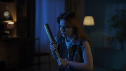 Young girl in casual with worried face breathing hard holding baseball bat and looking around for maniac, nervous atmosphere, thunderstorm outside. HDR BT2020 HLG Material.