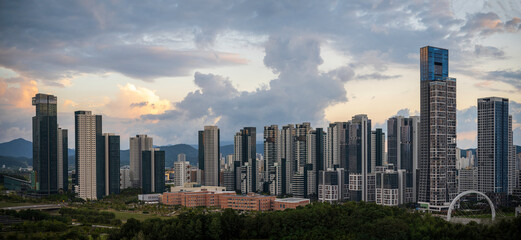 Fototapeta na wymiar Sejong City Panoramic Skyline and tall buildings at sunset with dramatic clouds with warm glow over skyscrapers