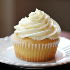 A vanilla cupcake with vanilla buttercream frosting