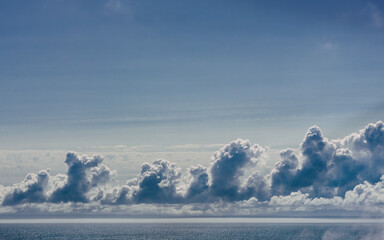 Background of puffy clouds and blue sky