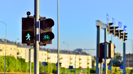 Pedestrian and bicycle traffic light with bicycle icon and active green resolving light on the...