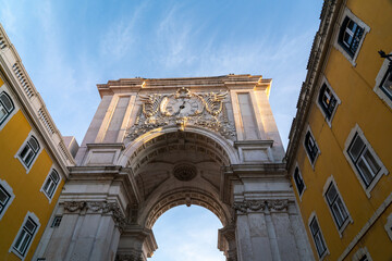 Fototapeta na wymiar Spectacular Arco da Rua Augusta - Lisbon - Portugal. Richly ornamented triumphal arch, from the c. XVIII, with carved figures and views towards the city center.. Beautiful sunset colours