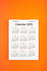 The 12 months desk calendar 2022 on orange color background.