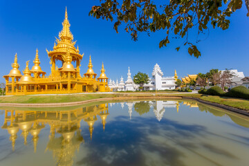The Gold pagoda in Wat Rong Khun or White Temple, Landmark, Chiang Rai, Thailand. - obrazy, fototapety, plakaty