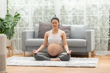 Poster Happy Calm Pregnant Woman deep breath with fresh air do yoga lotus pose comfortable at home,Pregnancy of young woman relax with yoga to meditation for healthy life,Yoga Motherhood and Pregnant Concept © 220 Selfmade studio