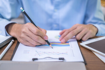 Closeup professional businessman hand pen writing work document strategy on tablet technology indoor workplace office table, adult entrepreneur business man manager person note finance report notepad