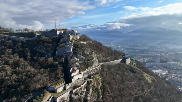 Skyward view: Grenoble, where Bastille's shadow meets river and innovation.
