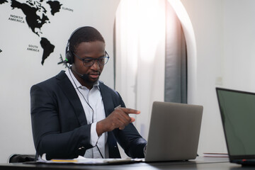 Portrait of business people wearing headset working actively in office. Call center, telemarketing, customer support agent provide service on telephone video conference call.