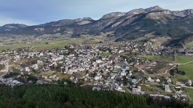 Aerial sweep: Villard-de-Lans, nature's masterpiece meets local heritage.
