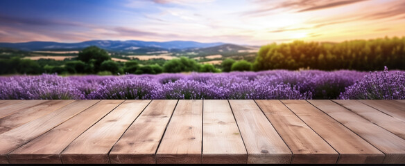Empty rustic old wooden boards table copy space with purple lavender flowers field in background....