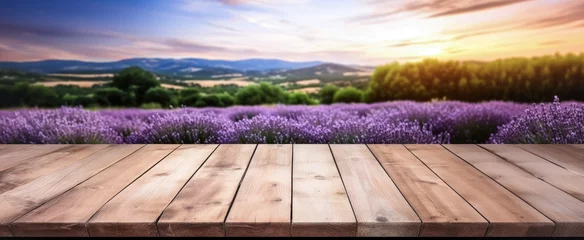 Fototapeten Empty rustic old wooden boards table copy space with purple lavender flowers field in background. Product display template. Generative AI © Lubo Ivanko